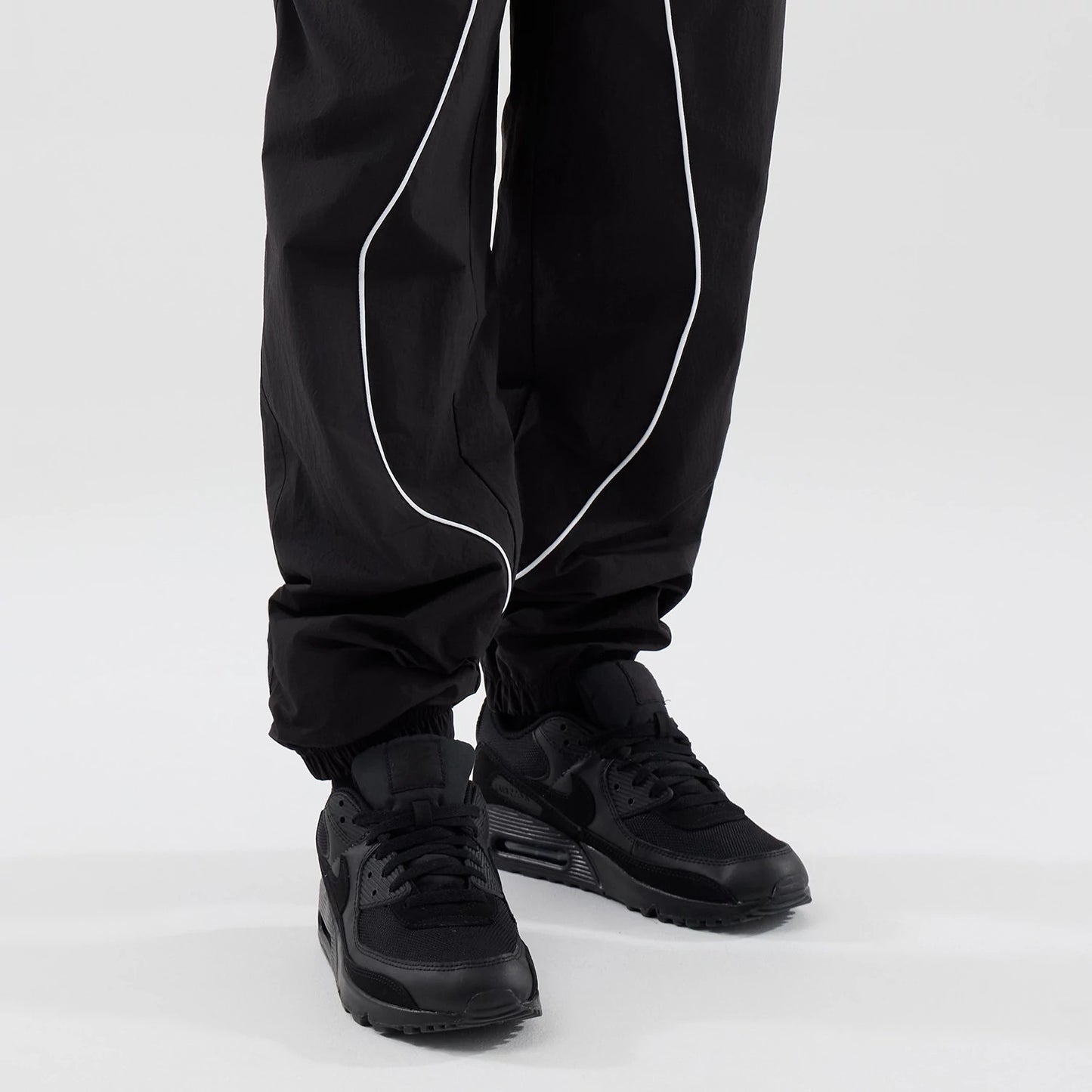 The model is wearing these MLB Piping Track LA Dodgers Track Pants in black. 7