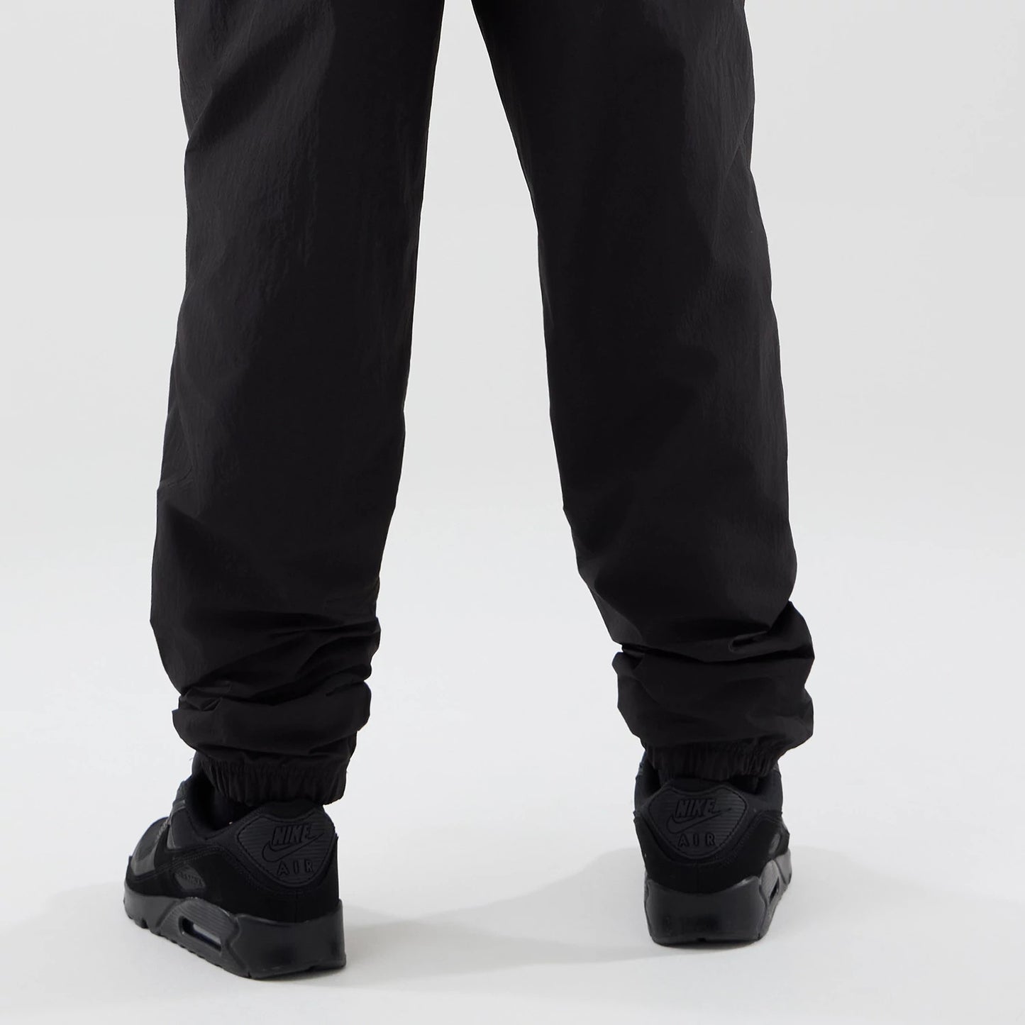 The model is wearing these MLB Piping Track LA Dodgers Track Pants in black. 4