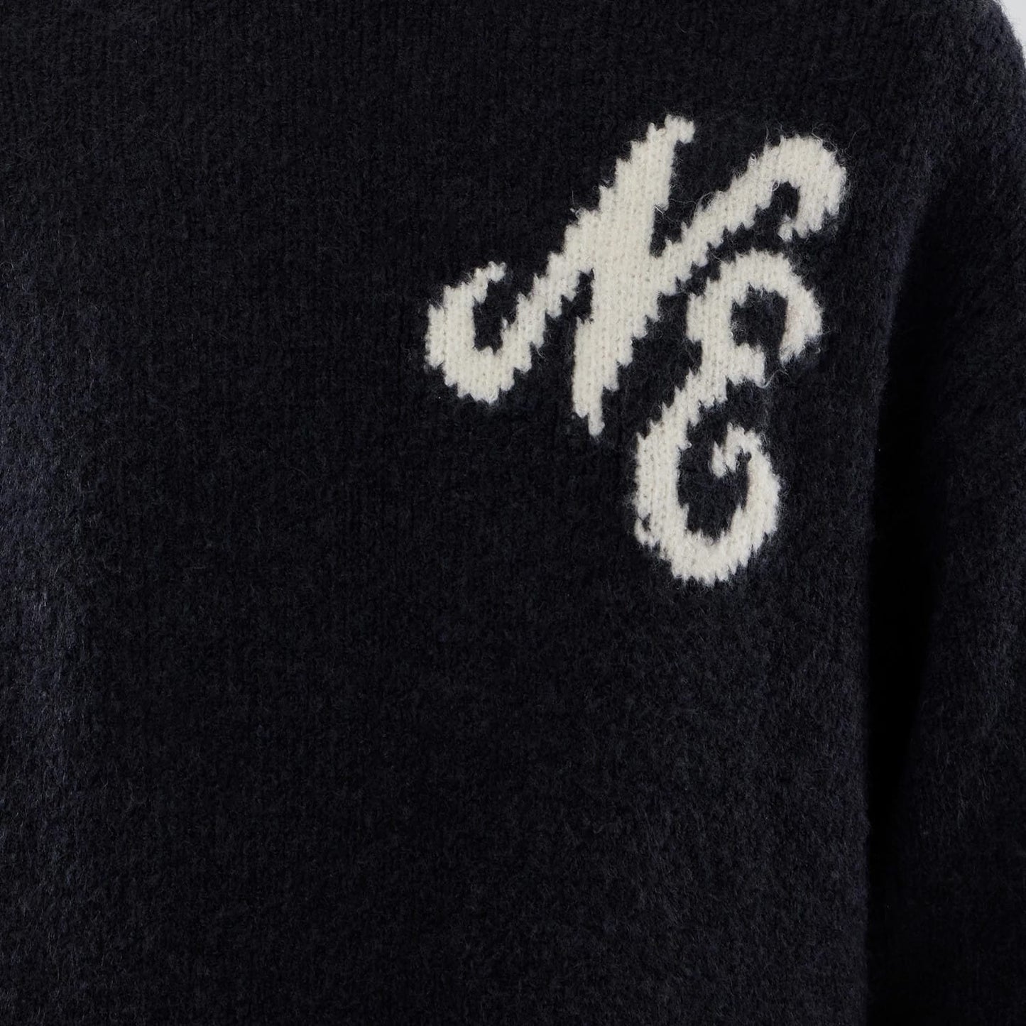 The model is wearing this New Era Knit Heritage Knitted Sweater in navy. 6