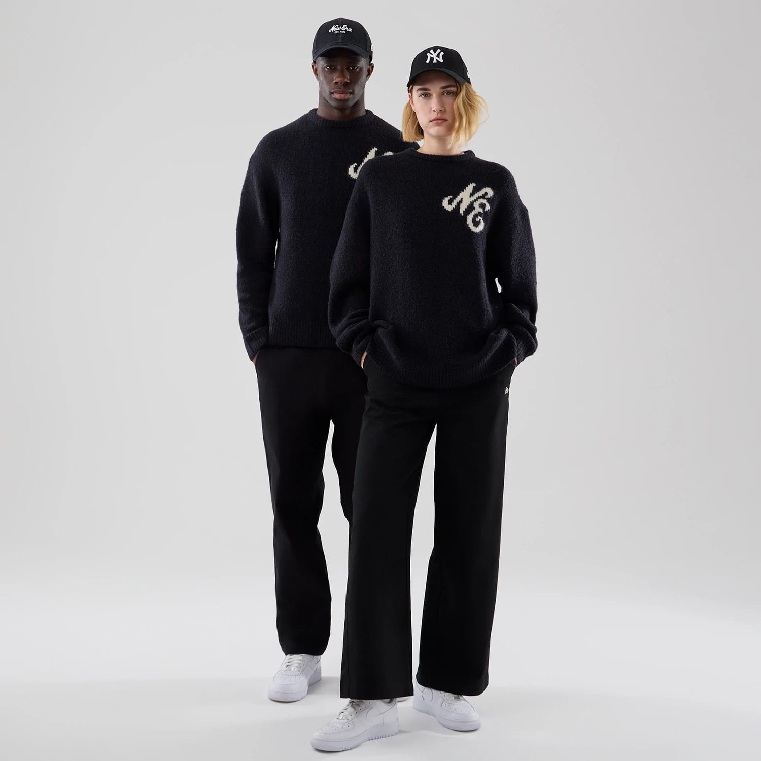 The model is wearing this New Era Knit Knitted Sweater in navy. 1