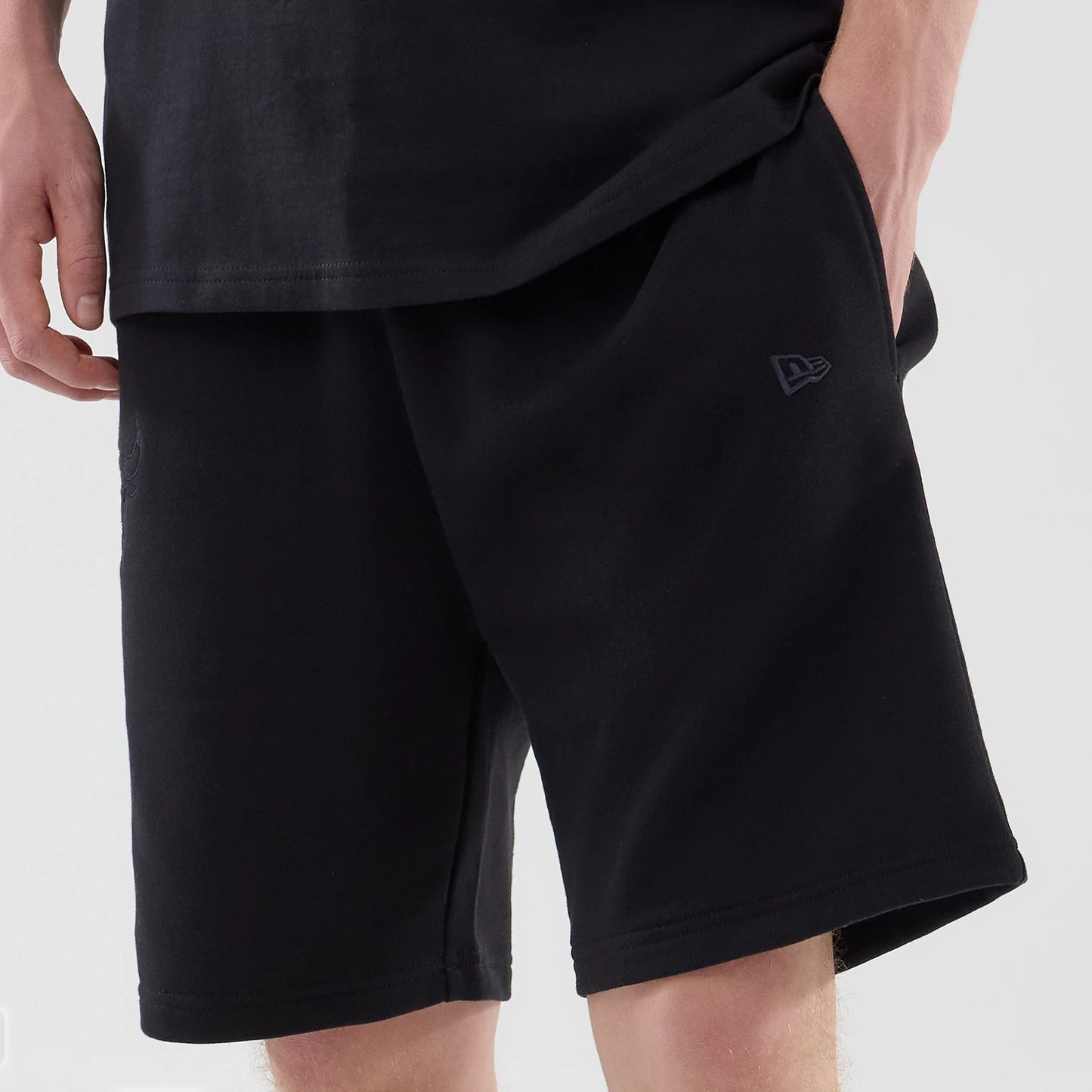 The model is wearing these NBA League Essential Chicago Bulls Oversized Shorts in black. 6