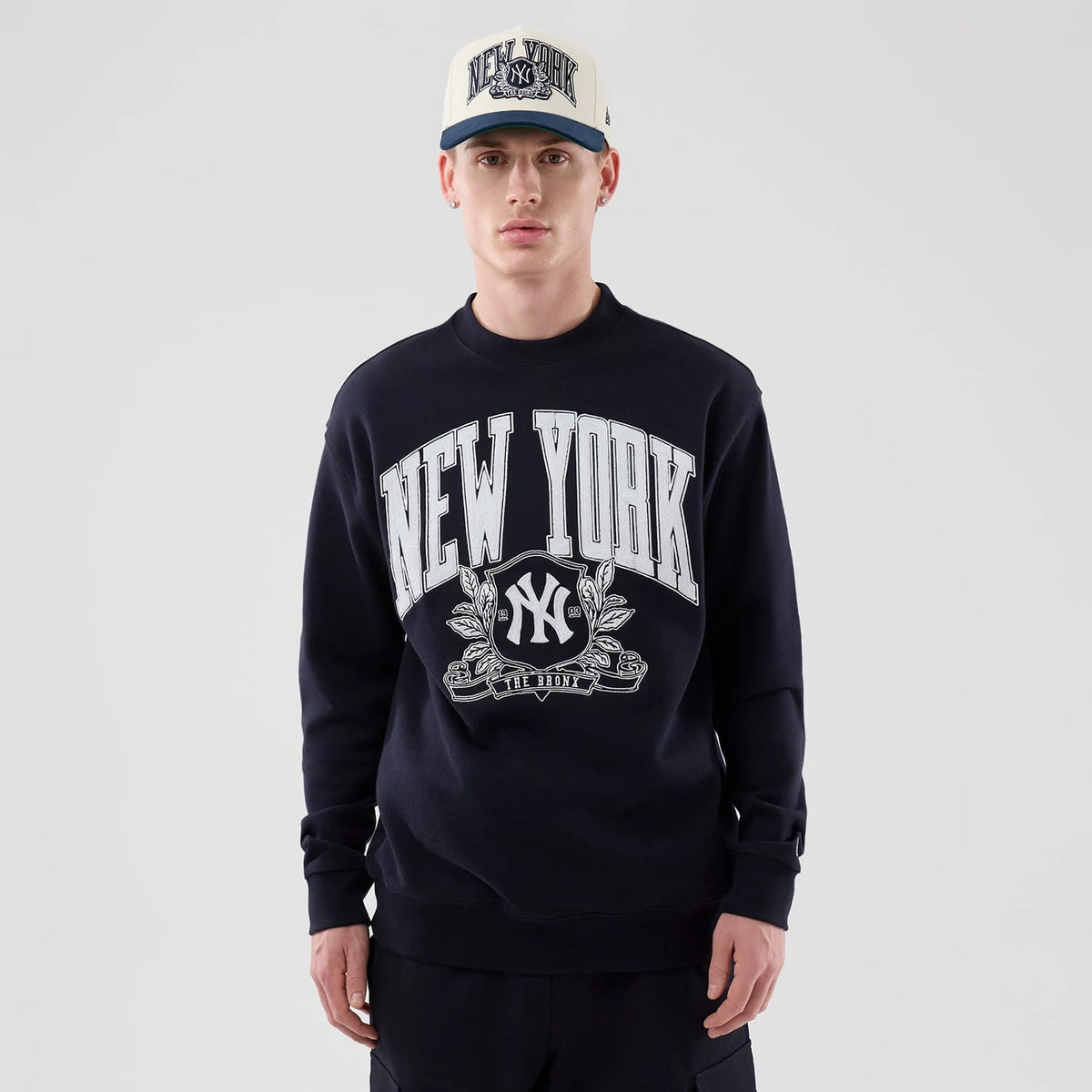 The model is wearing this MLB Arch Graphic New York Yankees Oversized Crew Neck Sweater in navy. 3