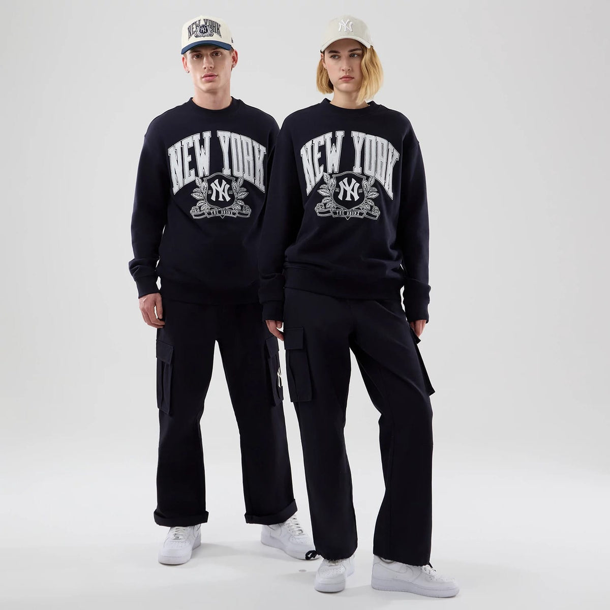 The model is wearing this MLB Arch Graphic New York Yankees Oversized Crew Neck Sweater in navy. 1
