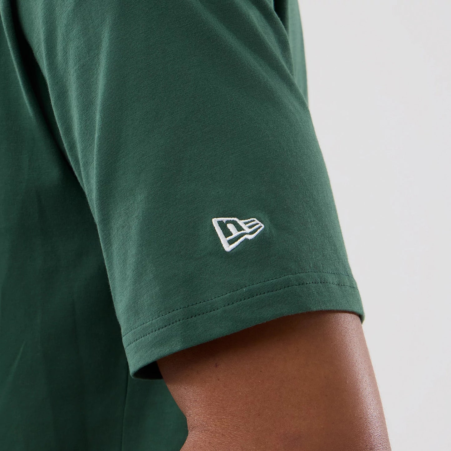 The model is wearing this MLB Food Graphic New York Yankees Oversized T-Shirt in dark green. 5