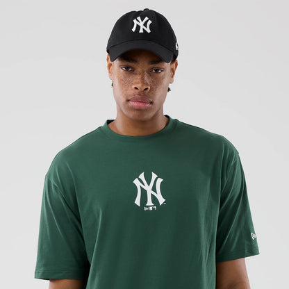 The model is wearing this MLB Food Graphic New York Yankees Oversized T-Shirt in dark green. 6
