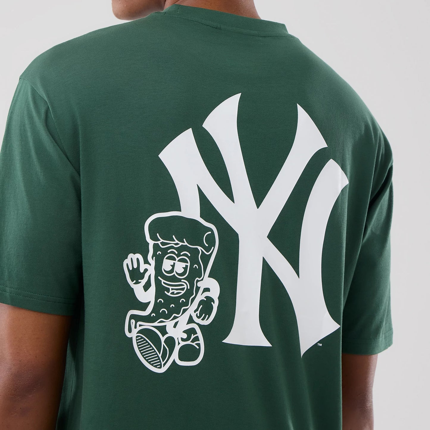 The model is wearing this MLB Food Graphic New York Yankees Oversized T-Shirt in dark green. 7