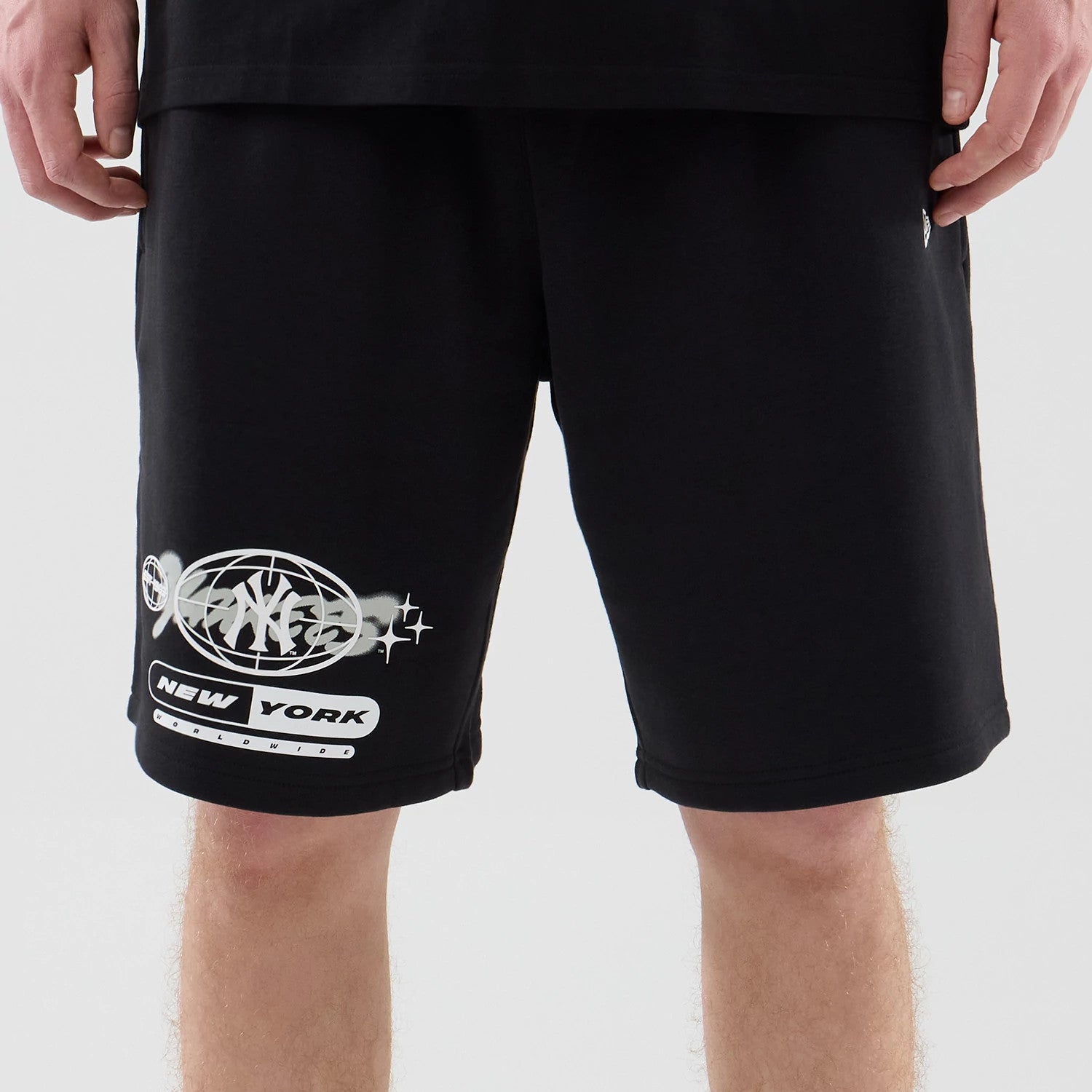 The model is wearing these MLB Logo Graphic New York Yankees Oversized Shorts in black. 3