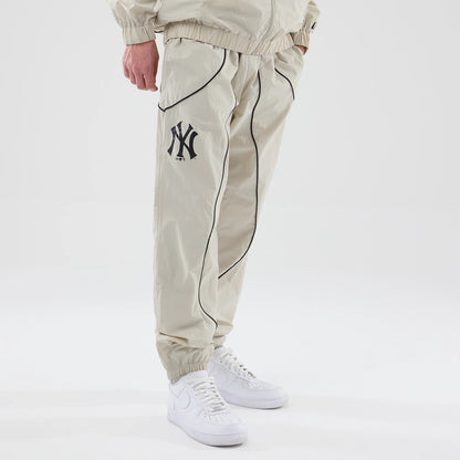 The model is wearing these MLB Piping Track New York Yankees Track Pants in cream. 3