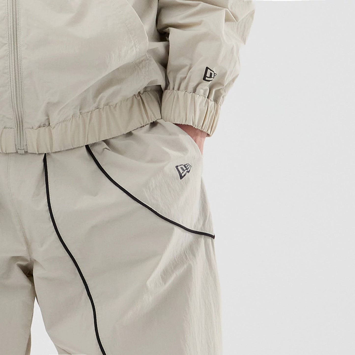 The model is wearing these MLB Piping Track New York Yankees Track Pants in cream. 5