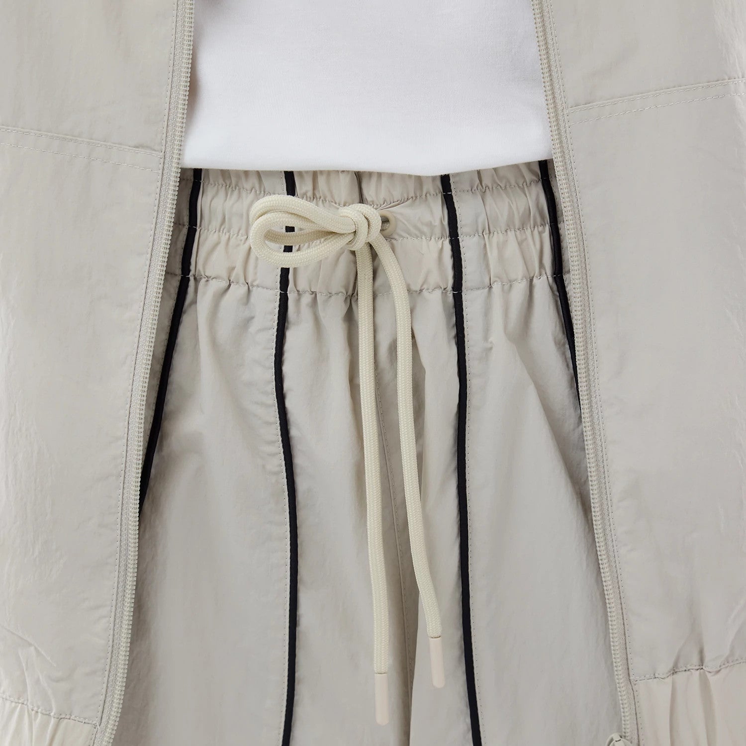 The model is wearing these MLB Piping Track New York Yankees Track Pants in cream. 6