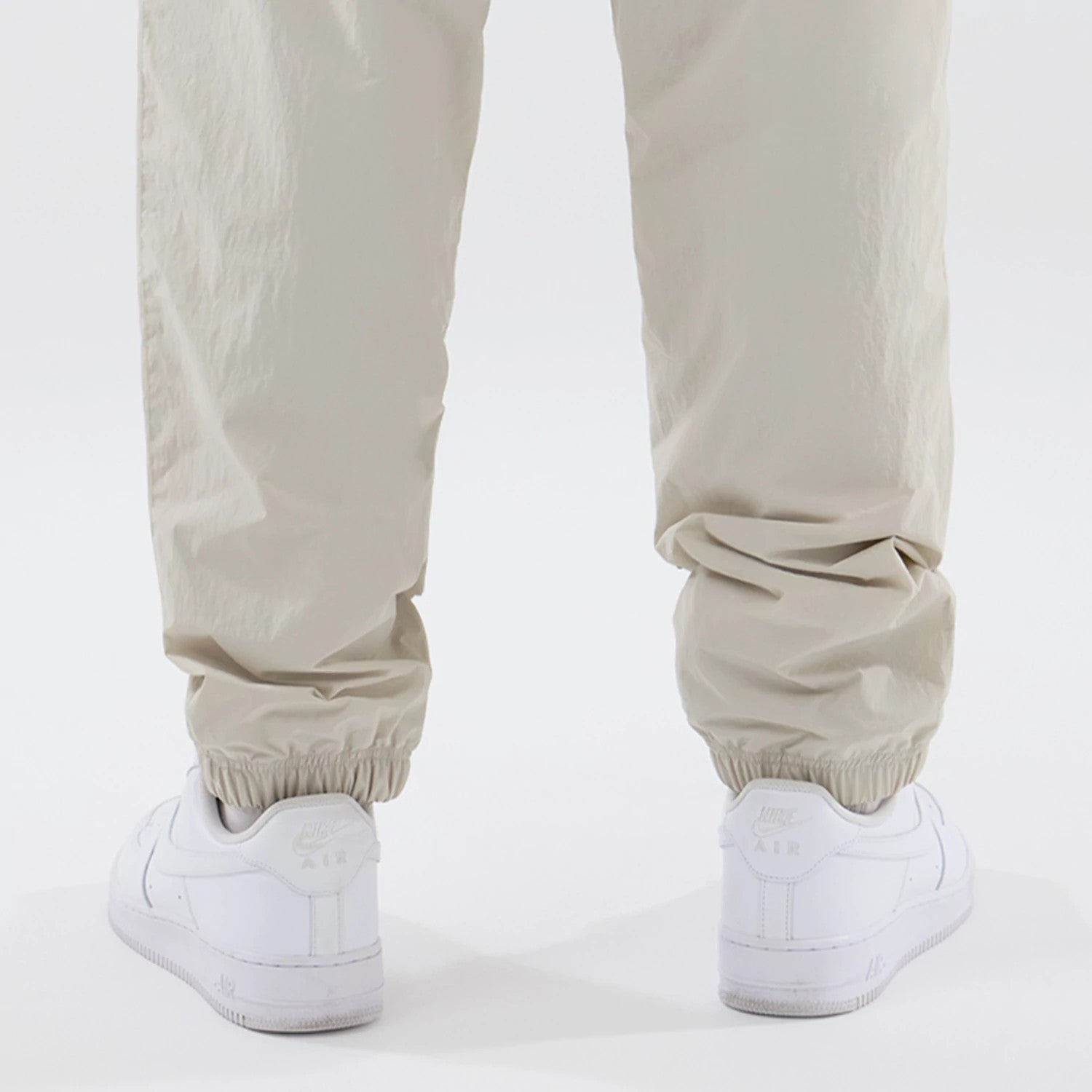 The model is wearing these MLB Piping Track New York Yankees Track Pants in cream. 7