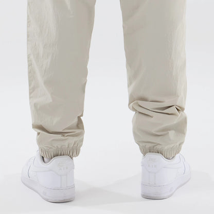 The model is wearing these MLB Piping Track New York Yankees Track Pants in cream. 7