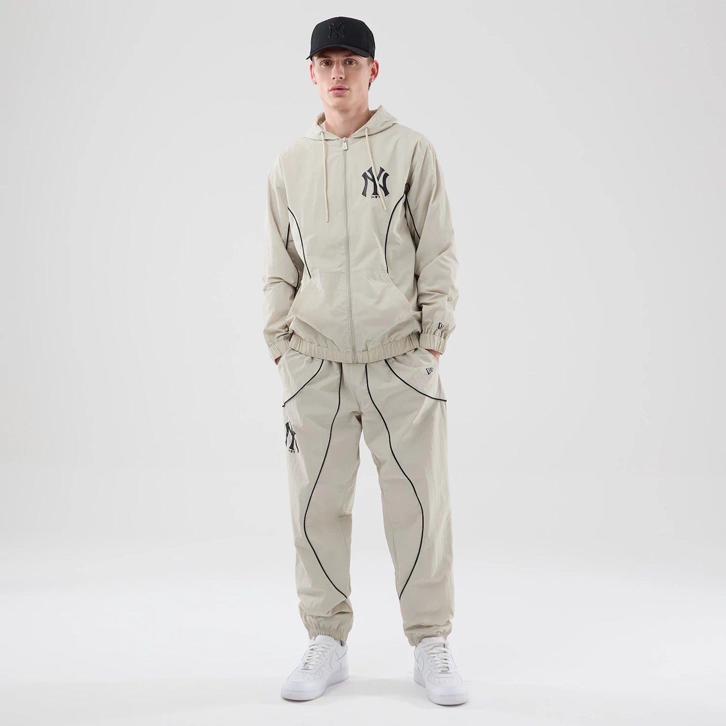 The model is wearing these MLB Piping Track New York Yankees Track Pants in cream. 8