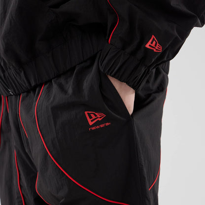 The model is wearing these Red Bull Racing Piping Track Pants in black. 6