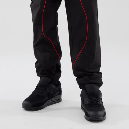 The model is wearing these Red Bull Racing Piping Track Pants in black. 7