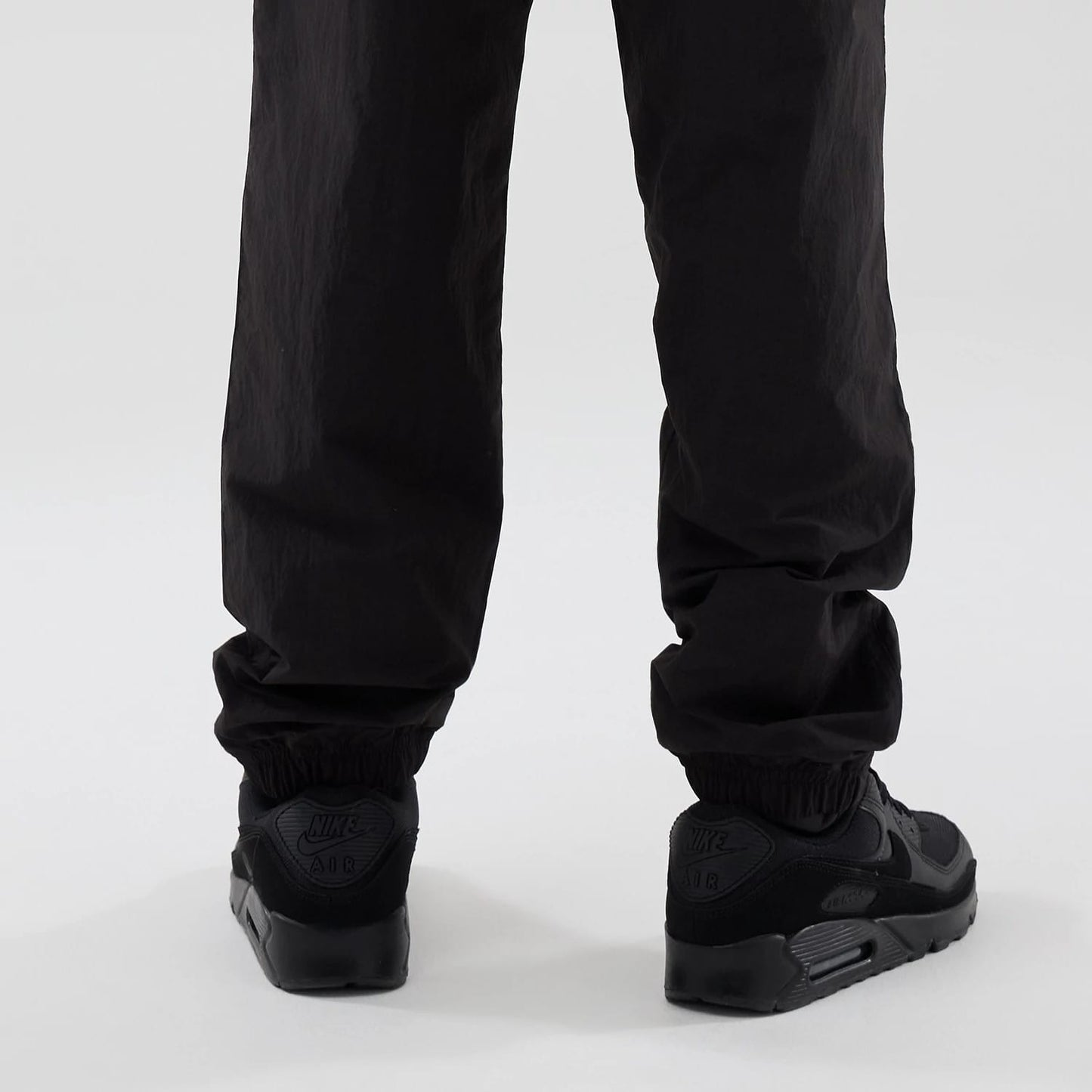 The model is wearing these Red Bull Racing Piping Track Pants in black. 3