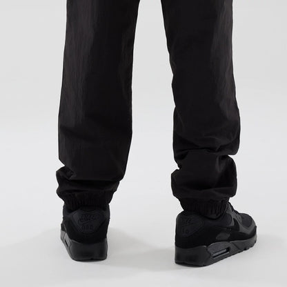 The model is wearing these Red Bull Racing Piping Track Pants in black. 3