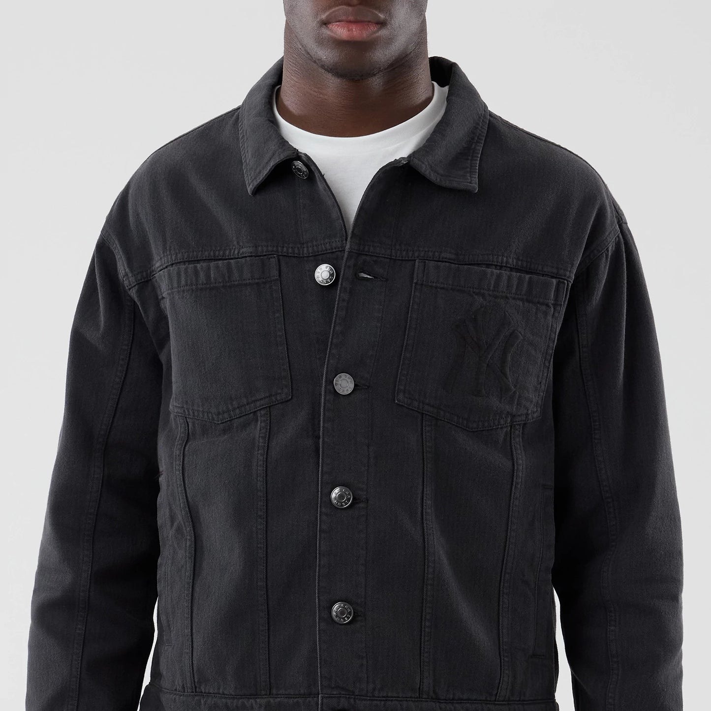 The model is wearing this MLB Stripe Denim New York Yankees Jacket in grey. 3