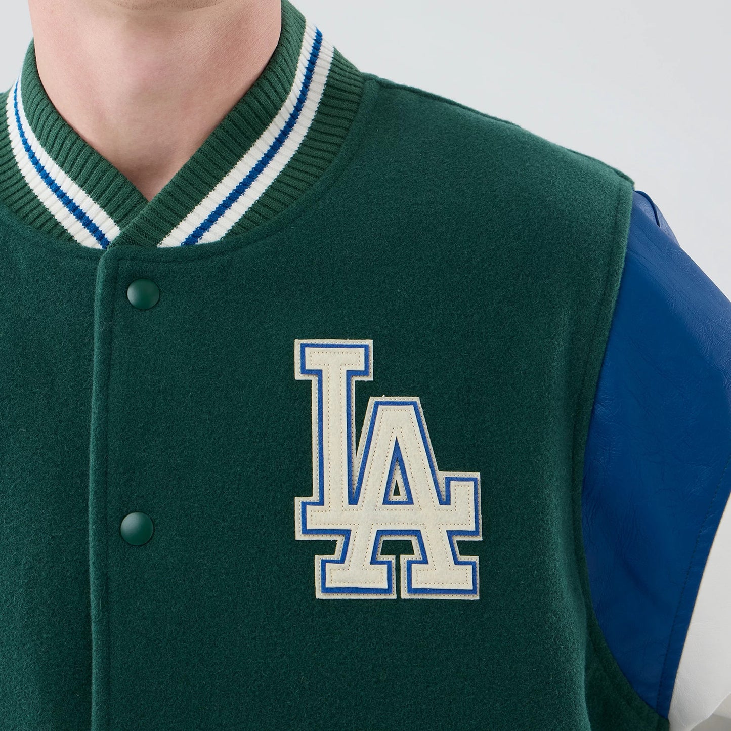 The model is wearing this MLB Varsity LA Dodgers Jacket in dark green. 5