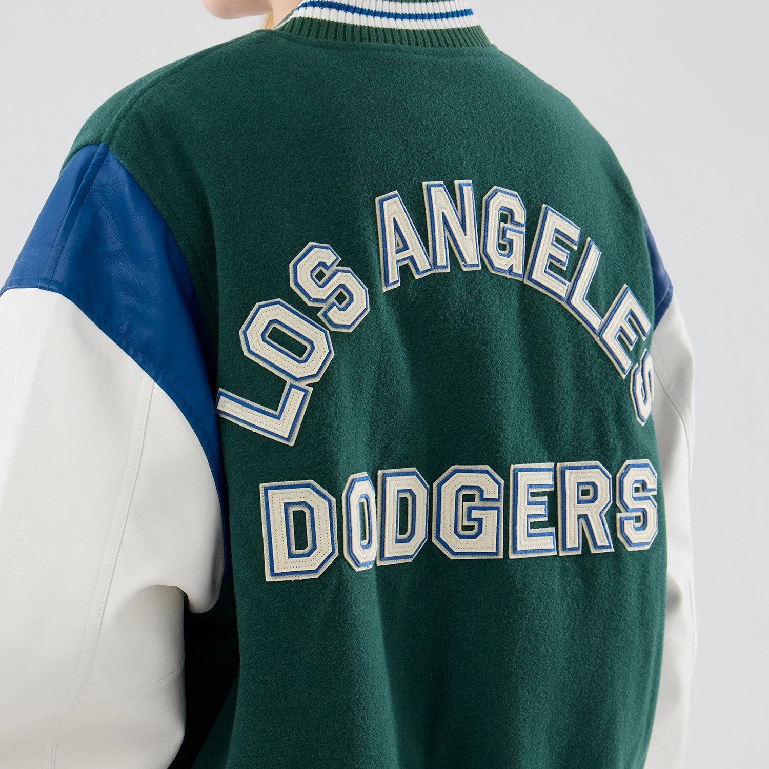 The model is wearing this MLB Varsity LA Dodgers Jacket in dark green. 8