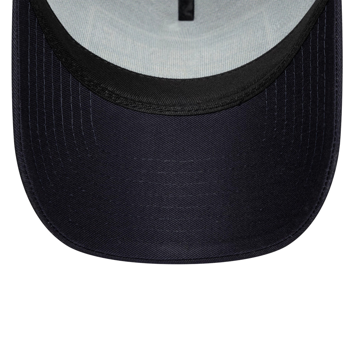 Newcastle United FC Navy New Era 9FORTY E-Frame Trucker Adjustable Cap, inside view showing the structured navy visor with stitching, a black sweatband along the edge, and a contrasting light grey undervisor.