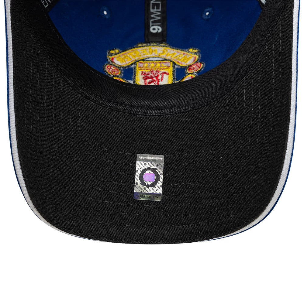 Manchester United FC 96 Blue New Era 9TWENTY Adjustable Cap, inside view showing the blue sweatband against the cap’s interior, black undervisor with the authenticity sticker, and detailed embroidered Manchester United crest on the inside top.