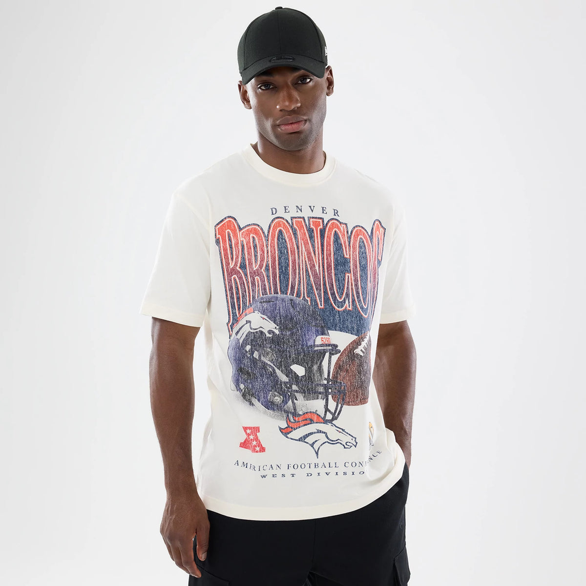 New Era Denver Broncos NFL Sport Classic Cream T-Shirt, front view on-model showing a large vintage Denver Broncos graphic with a football helmet and Broncos lettering across the chest, complemented by team and conference details below.