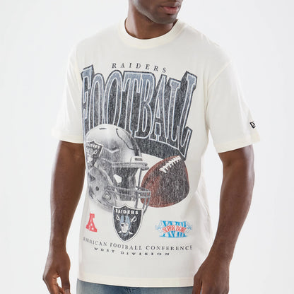 New Era Las Vegas Raiders NFL Sport Classic Cream T-Shirt, front view on-model showcasing a large graphic of a Raiders helmet with a football and FOOTBALL lettering, small patches below, and an embroidered New Era logo on the left sleeve.
