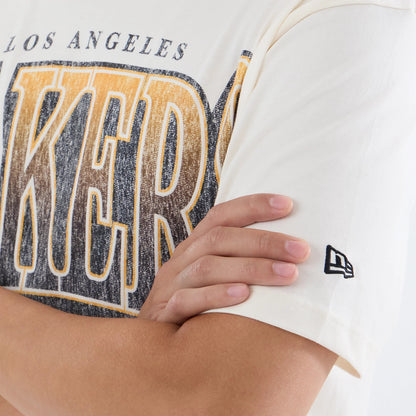 New Era LA Lakers NBA Sport Classic Cream T-Shirt, front view showcasing the distressed Lakers graphic across the chest in yellow with black outline, Los Angeles lettering above, and the New Era embroidered logo on the left sleeve near the cuff.