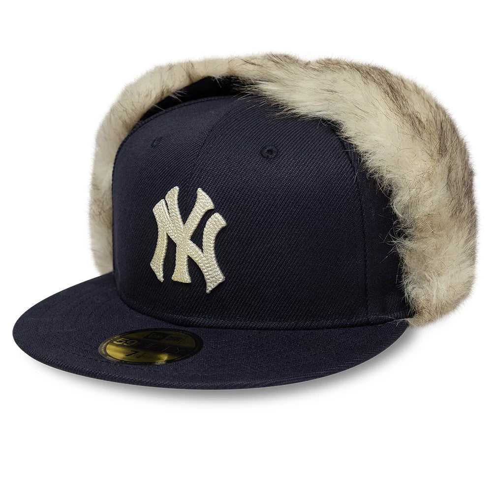 New York Yankees MLB Cotton Canvas Navy Dogear New Era 59FIFTY Fitted Cap, three-quarter view showing the cream New York Yankees logo in raised embroidery on the front panel, with faux fur-lined dogear flaps.