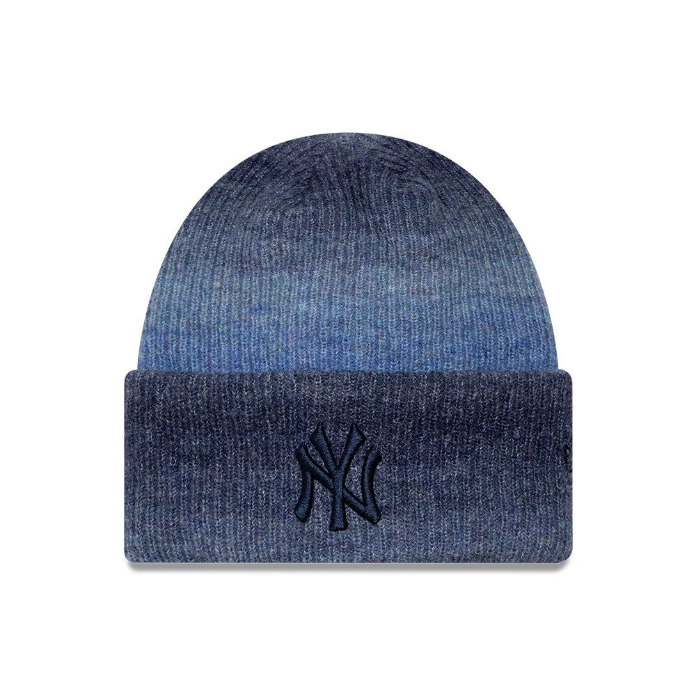 New Era New York Yankees Womens MLB Ombre Navy Cuff Knit Beanie Hat, front view showing the gradient navy to blue ombre design, with a raised embroidered NY logo centred on the fold-over cuff, highlighting the knit texture.