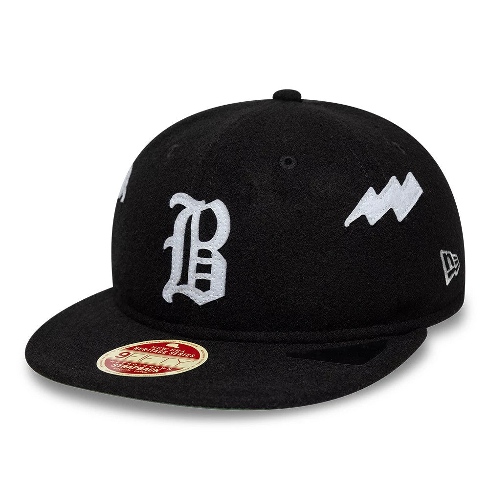 Atlanta Braves MLB Heritage Black Retro Crown New Era 9FIFTY Adjustable Cap, front view showing a white embroidered B logo on the black crown, with a red 9FIFTY size sticker on the flat visor and additional white logos on the side.