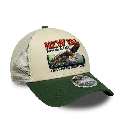 Pictured is this New Era Graphic 9FORTY M-Crown A-Frame Trucker cap in cream. 3