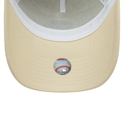 New York Yankees MLB Outline Cream New Era 9FORTY E-Frame Trucker Adjustable Cap, inside view showing the cream undervisor with detailed stitching and a baseball-themed sticker, featuring white interior taping.