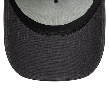 New Era Distressed Patch Charcoal New Era 9FORTY E-Frame Trucker Adjustable Cap, inside view showing a pale green undervisor with a black interior edge, black stitching, and curved visor on the hat.