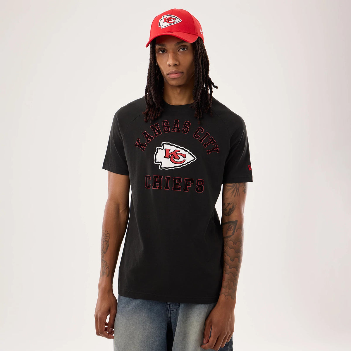 New Era Kansas City Chiefs NFL Sideline 2026 Black T-Shirt, front view on-model showing red embroidered KC Chiefs logo centred on the chest with 'Kansas City Chiefs' lettering around it and a New Era logo on the left sleeve.