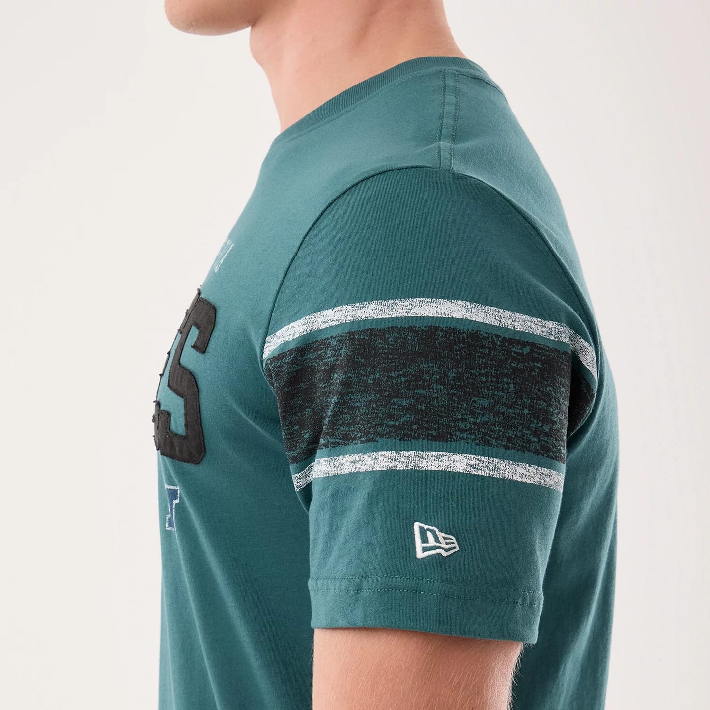The model is wearing this NFL Sideline 2026 Philadelphia Eagles T-Shirt in dark green. 5