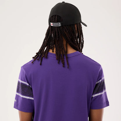 The model is wearing this NFL Sideline 2026 Baltimore Ravens T-Shirt in purple. 7
