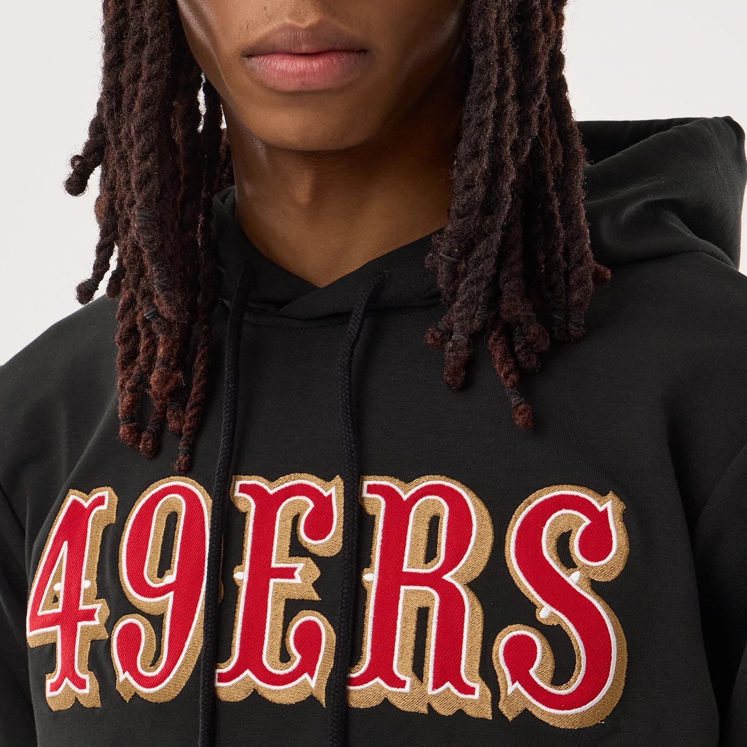 The model is wearing this NFL Sideline 2026 San Francisco 49ers Double Sleeve Hoodie in black. 3