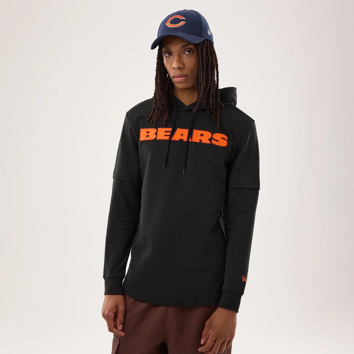 The model is wearing this NFL Sideline 2026 Chicago Bears Double Sleeve Hoodie in black. 1