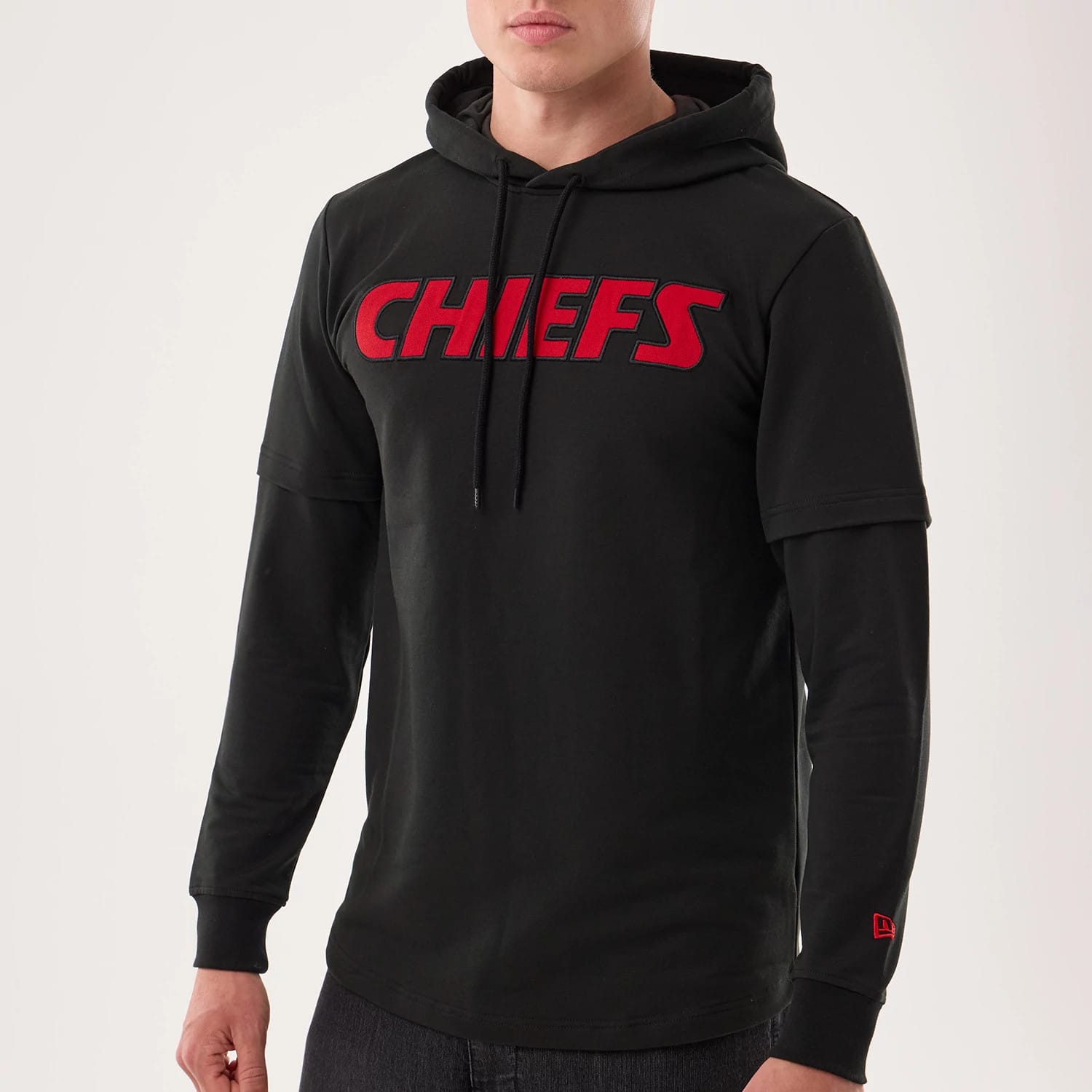 The model is wearing this NFL Sideline 2026 Kansas City Chiefs Double Sleeve Hoodie in black. 3