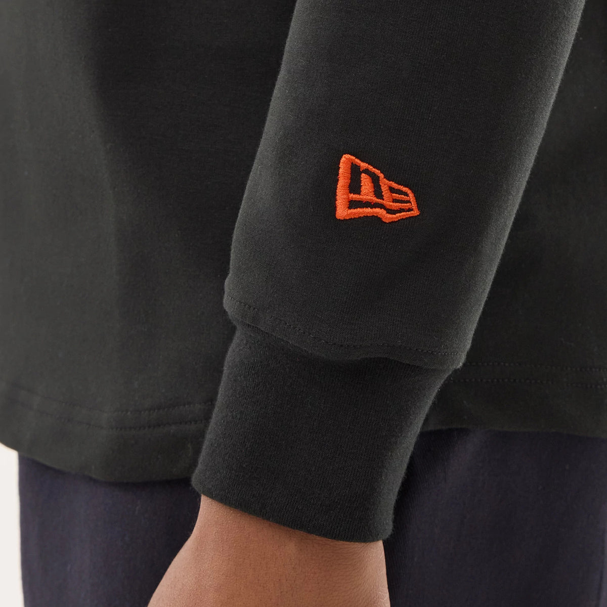 The model is wearing this NFL Sideline 2026 Denver Broncos Double Sleeve Hoodie in black. 5