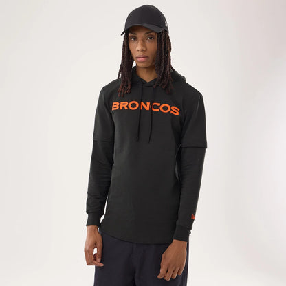The model is wearing this NFL Sideline 2026 Denver Broncos Double Sleeve Hoodie in black. 1
