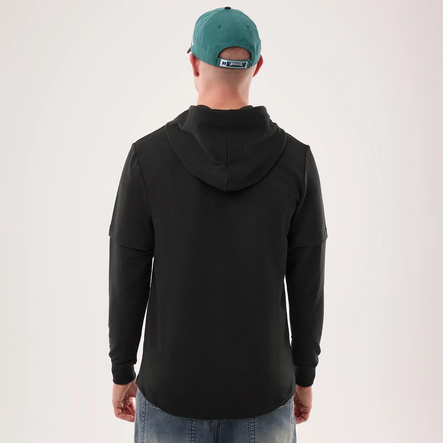 The model is wearing this NFL Sideline 2026 Philadelphia Eagles Double Sleeve Hoodie in black. 2