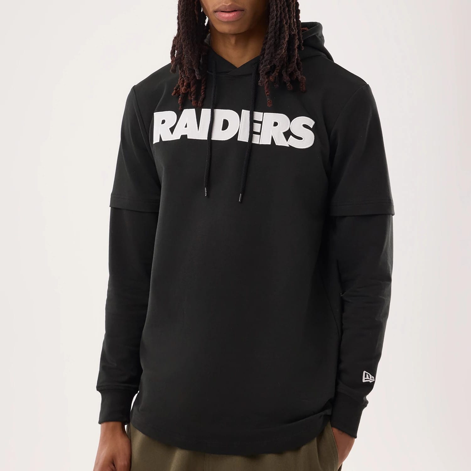 The model is wearing this NFL Sideline 2026 Las Vegas Raiders Double Sleeve Hoodie in black. 4