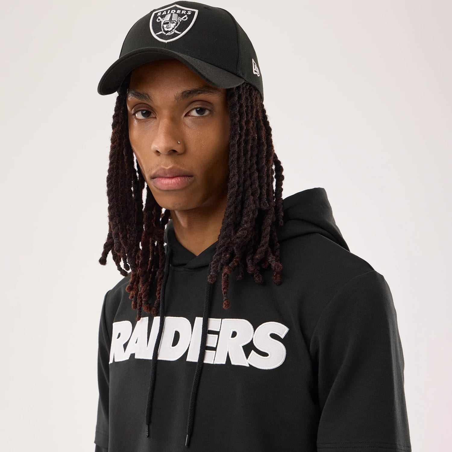 The model is wearing this NFL Sideline 2026 Las Vegas Raiders Double Sleeve Hoodie in black. 6