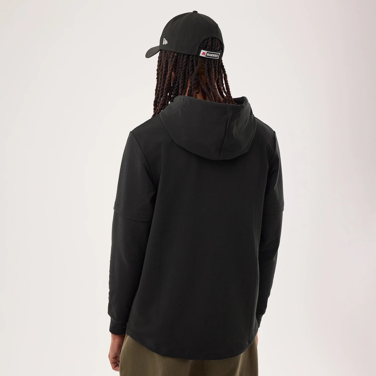 The model is wearing this NFL Sideline 2026 Las Vegas Raiders Double Sleeve Hoodie in black. 2