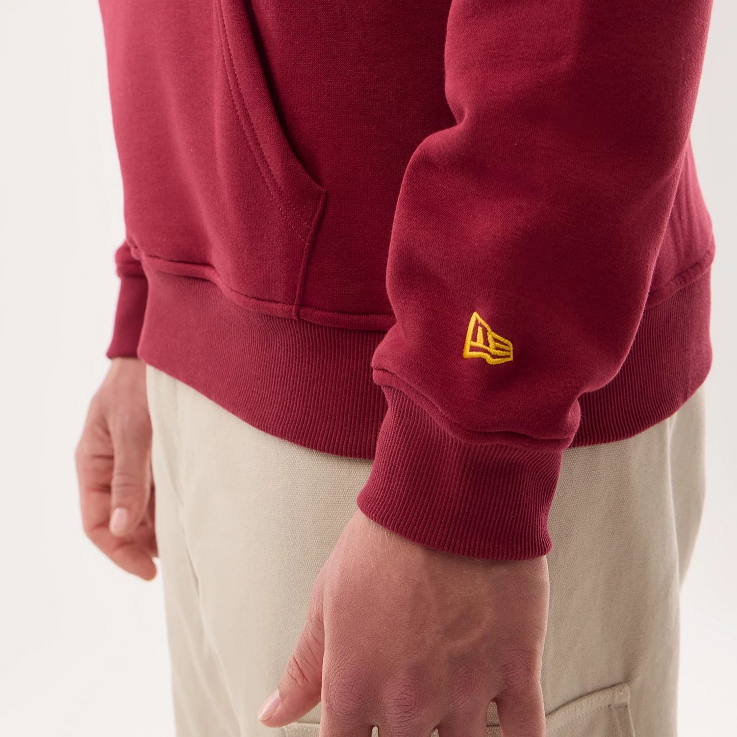 The model is wearing this NFL Sideline 2026 Washington Commanders Pullover Hoodie in dark red. 6