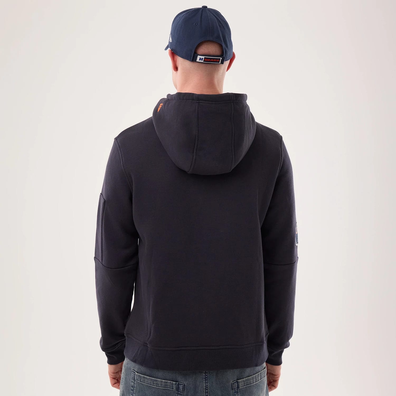 The model is wearing this NFL Sideline 2026 Chicago Bears Pullover Hoodie in navy. 2