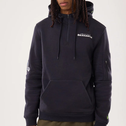 The model is wearing this NFL Sideline 2026 Seattle Seahawks Pullover Hoodie in navy. 3